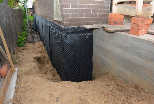 SJ Waterproofing Pros technician performing targeted Wet Basement Repair assessment in Lyons, KS